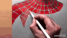 a person is drawing a spider man with a pencil