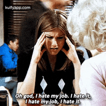 a woman is holding her head while talking to another woman and says `` oh god , i hate my job .