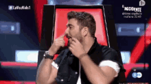 a man with a beard is sitting in a chair with the words lavozkids1 on the screen behind him
