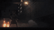 a man in a black suit is standing in the dark