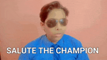 a boy wearing sunglasses and a blue shirt says " salute the champion "