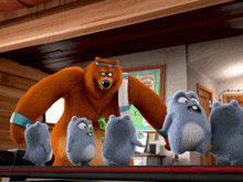 a bear with a towel around his neck is standing next to a group of cartoon animals