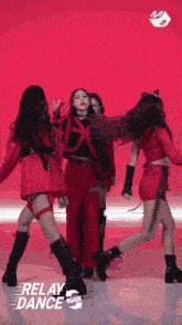 a group of girls are performing a relay dance on a stage
