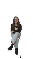 a woman sitting on a stool with her legs crossed