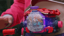 a person is wearing a purple and red item that says over