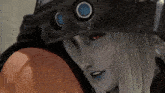 a woman with long white hair and red eyes is wearing a helmet with two circles on it .