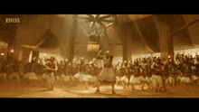 a group of people are dancing in a room with eros written on the bottom of the screen