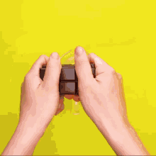 a person is pouring liquid into a red silicone tray