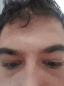 a close up of a person 's face with their eyes closed and their hair visible .