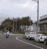 a man on a motorcycle is driving down a street