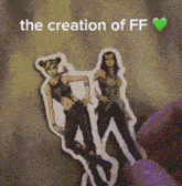 a person is holding a sticker of two women with the words the creation of ff above them .