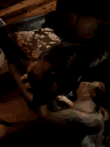 a person laying on a bed with a floral pillow