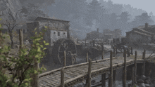 a wooden bridge over a river with a water wheel in the foreground