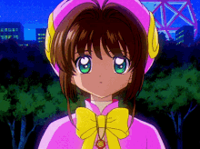a girl with green eyes is wearing a pink and yellow outfit with a yellow bow