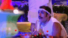 a pixelated image of a man with hearts around him and the words big brother brasil in the corner