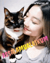 a woman holding a cat with the words assalamualaikum written on the bottom