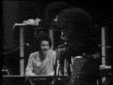 a man playing a keyboard in a black and white photo