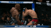 two men in a boxing ring with a toyo tires advertisement on the fence