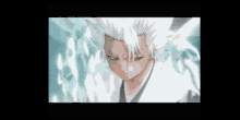 a close up of a bleach character with white hair and blue eyes standing in front of a wall of ice .