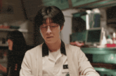 a man wearing glasses and a name tag that says ' e '