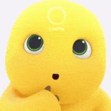 a yellow stuffed animal with green eyes and a white circle on its head