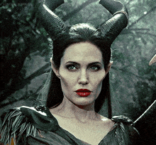 a woman with horns on her head looks at the camera with volcram tumblr written on the bottom right