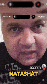a man 's face is displayed on a phone screen with the name natash at the top