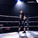 a man in a wrestling ring is wearing a shirt that says ' john cena '