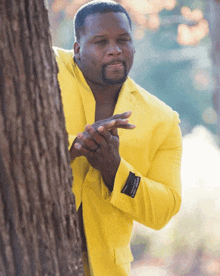 a man in a yellow jacket has a label on the sleeve that says ' cotton ' on it