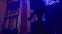 a silhouette of a person with glowing eyes in a dark room with a sign that says ' fox ' on it