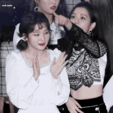 a group of girls are standing in a room with rock music written on the bottom right corner