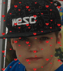 a boy wearing a hat that says wesc