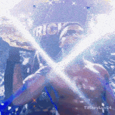 a shirtless man is holding a wrestling championship belt in front of a sign that says rick