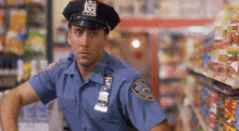 a police officer in a blue uniform is standing in a store .