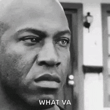 a black and white photo of a man 's face with the words `` what va '' written below him .