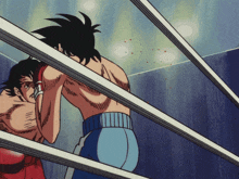 two boxers are fighting in a boxing ring and one of them is wearing red gloves