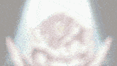 a blurred image of a person standing in front of a white light .