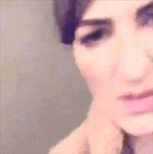 a close up of a woman 's face with a serious look on her face