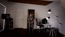 a man in a t-shirt with a chicken on it stands in a dark room