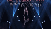 a man and a woman are performing aerial acrobatics on a stage with the words america 's got talent in the background