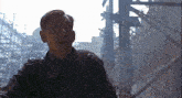 a man in a military uniform is standing in front of a building and talking