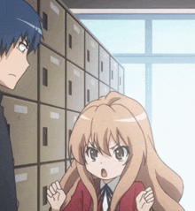a boy and a girl are standing in front of a row of lockers ..