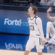 a basketball player wearing a number 13 jersey