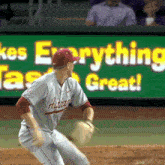 a baseball player in front of a sign that says ' everything great '
