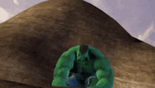 a green hulk is sitting on top of a rock in the desert .
