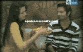 a man and a woman are sitting on a couch with apnicommunity.com written on the bottom