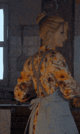 a woman is wearing an apron that says about