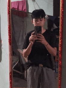 a young man is taking a selfie in front of a mirror