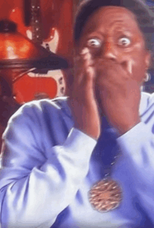 a man wearing a medal around his neck is making a funny face