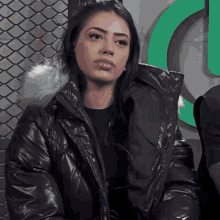a woman in a black jacket with a fur hood